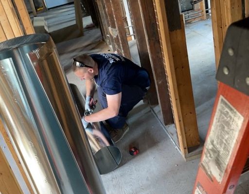 Pure Comfort technician fabricating and installing m
