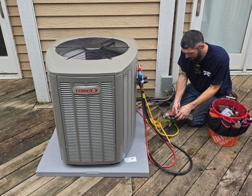 Pure Comfort technician starting up a new Lennox central air conditioner with gauge hoses connected