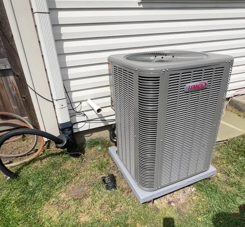 Lennox AC condenser on a new pad beside an Addison, IL home