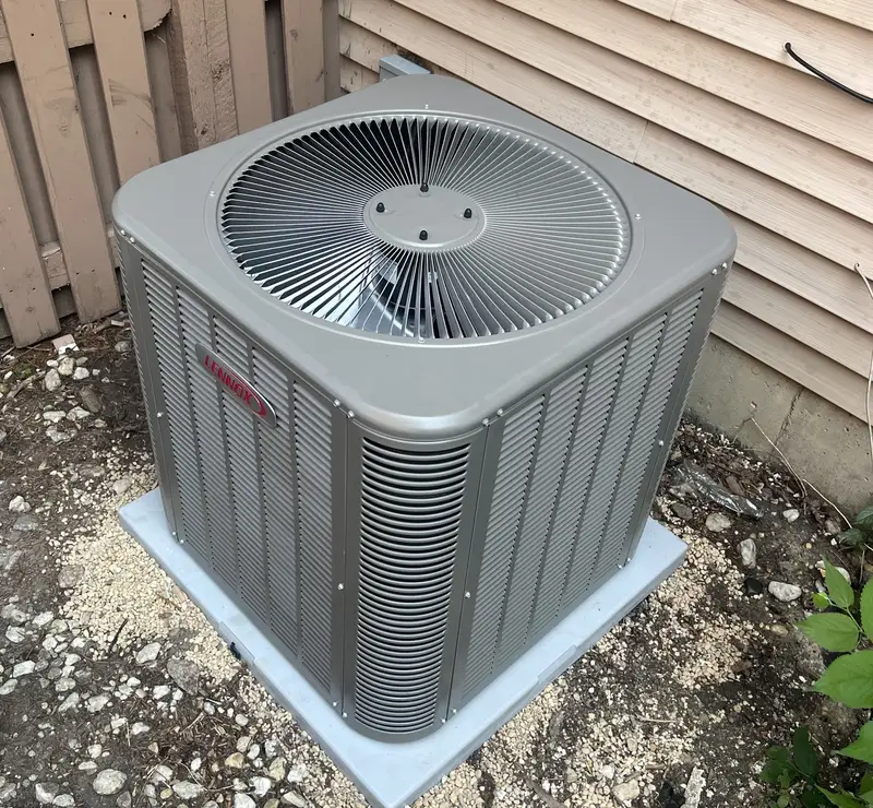 Lennox air conditioner on a new pad in an Addison, IL side yard