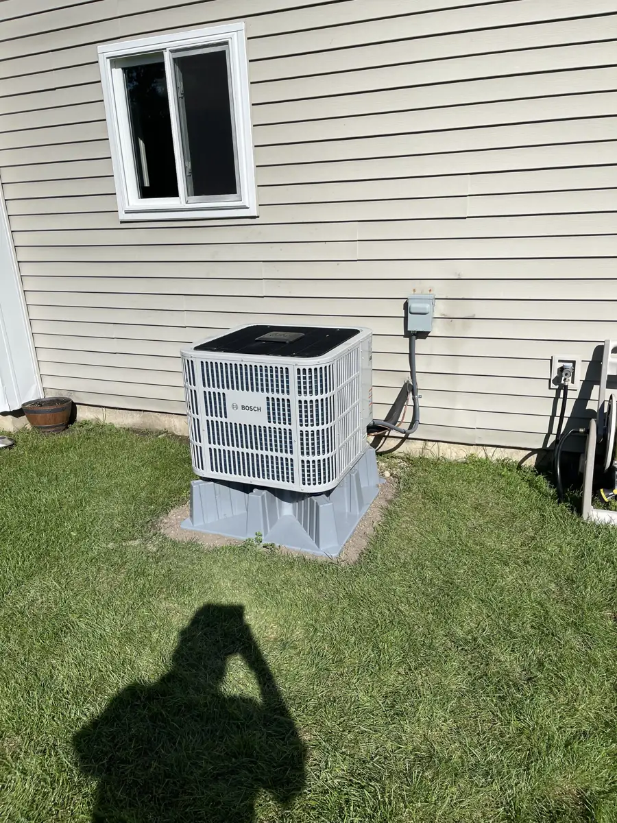 New Bosch heat pump on a raised pad at an Elgin, IL home