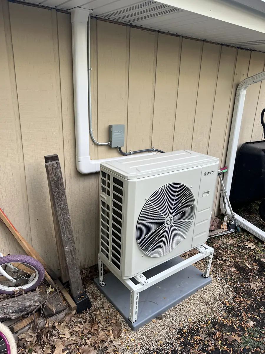Bosch heat pump outdoor unit on a stand with a line-hide cover at a Schaumburg, IL home