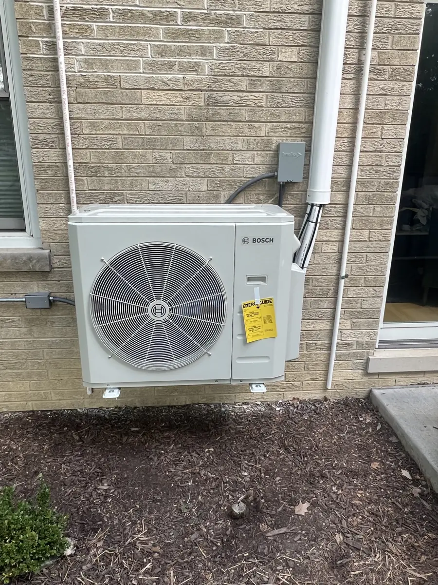 New Bosch ductless mini-split outdoor unit mounted on a brick wall in Elmhurst, IL