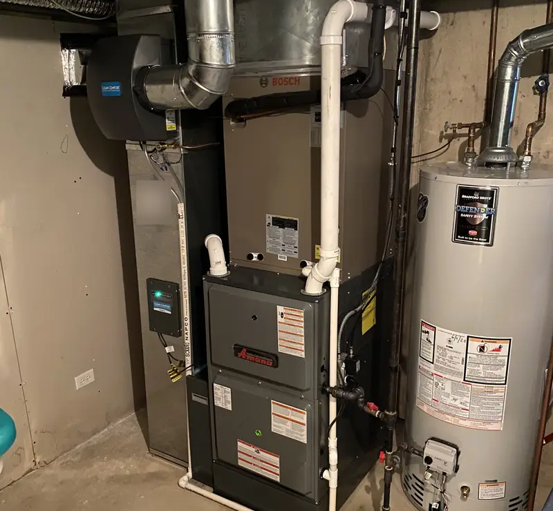 Amana high-efficiency furnace with Bosch coil and whole-home humidifier in an Inverness, IL basement
