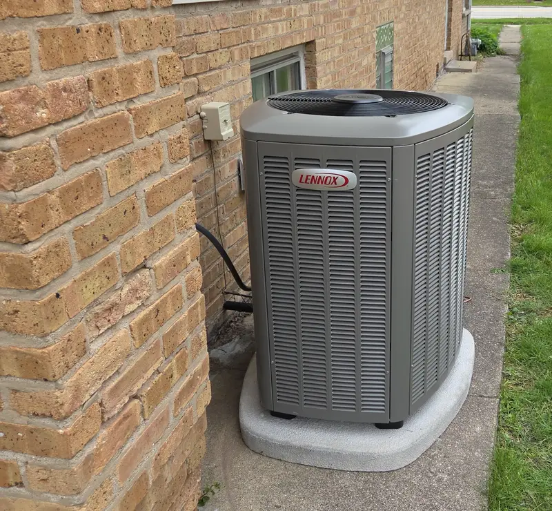 Lennox AC condenser on a new pad beside an Itasca, IL home