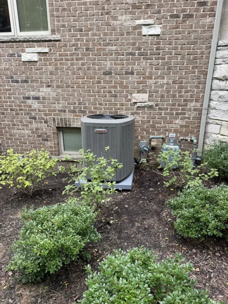 Lennox air conditioner condenser on a new pad at a Bartlett, IL home