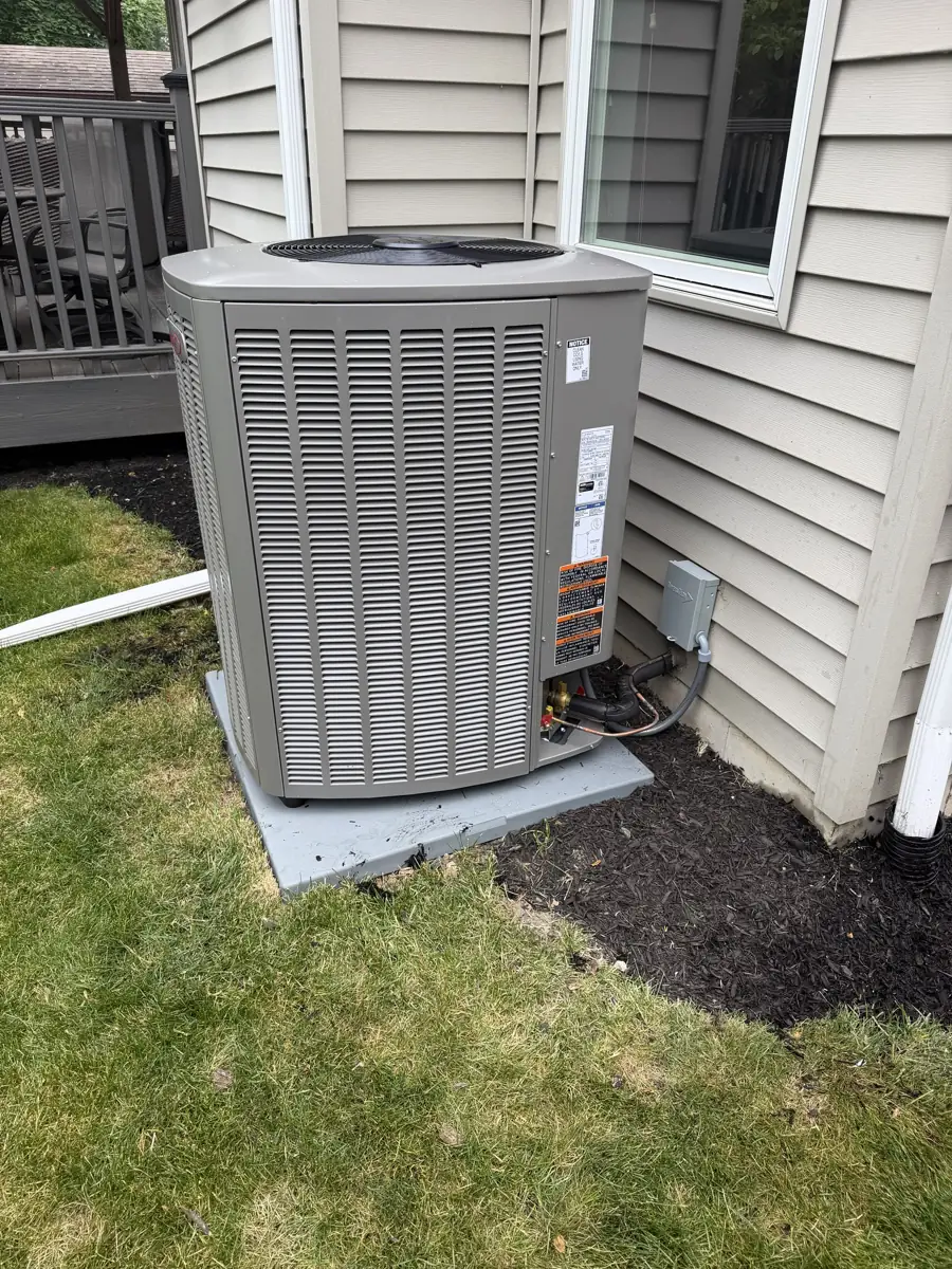 New Lennox air conditioner on a pad beside a deck at a Glen Ellyn, IL home