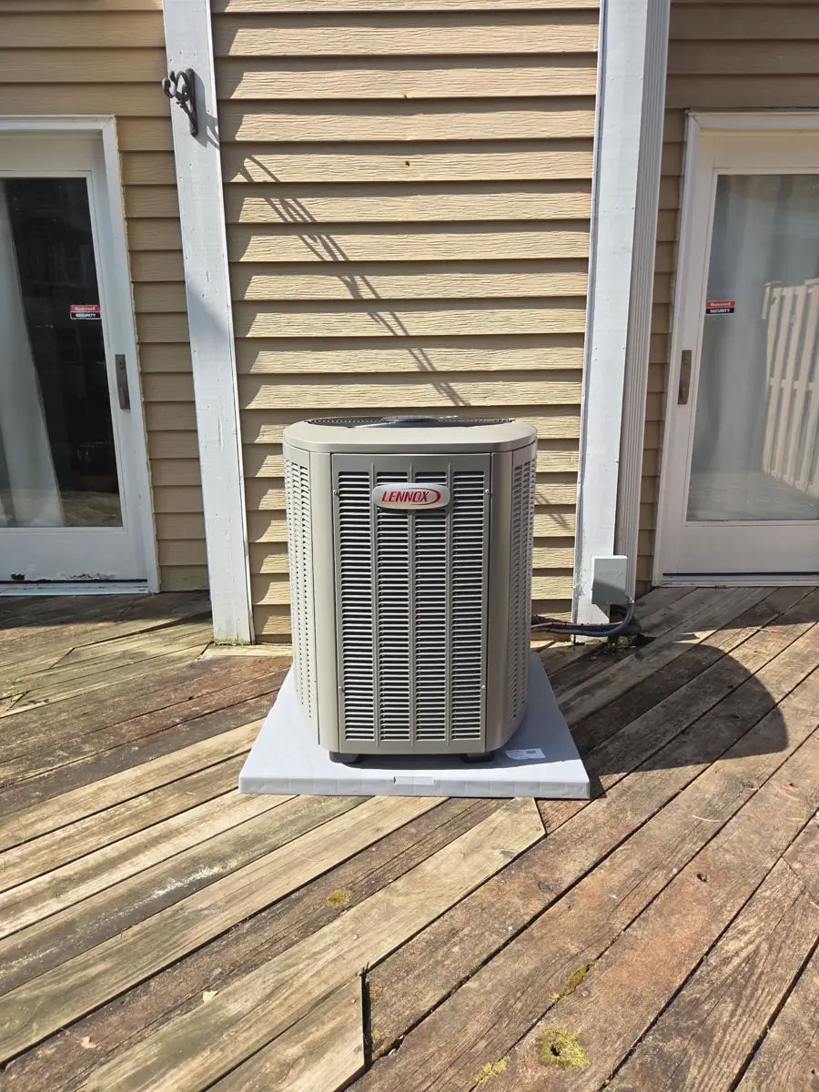 New Lennox air conditioner on a pad on a backyard deck in Streamwood, IL