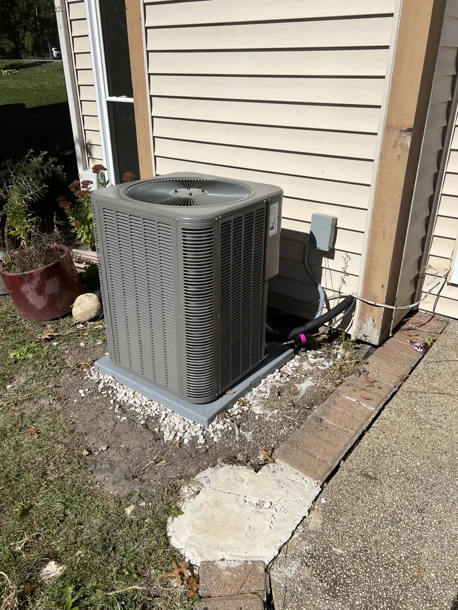 New Lennox air conditioner on a pad and gravel base at an Elgin, IL home