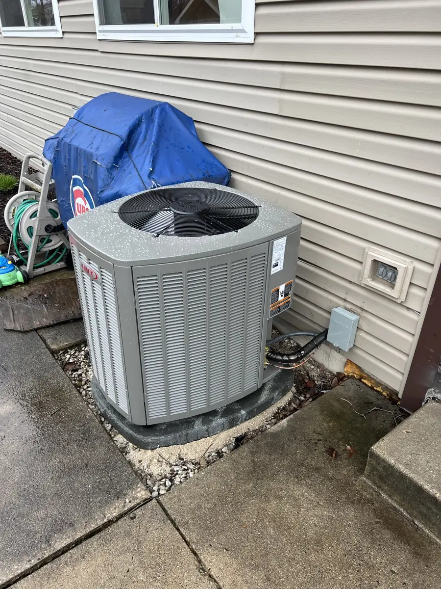 New Lennox air conditioner on a pad beside a patio at a Carol Stream, IL home