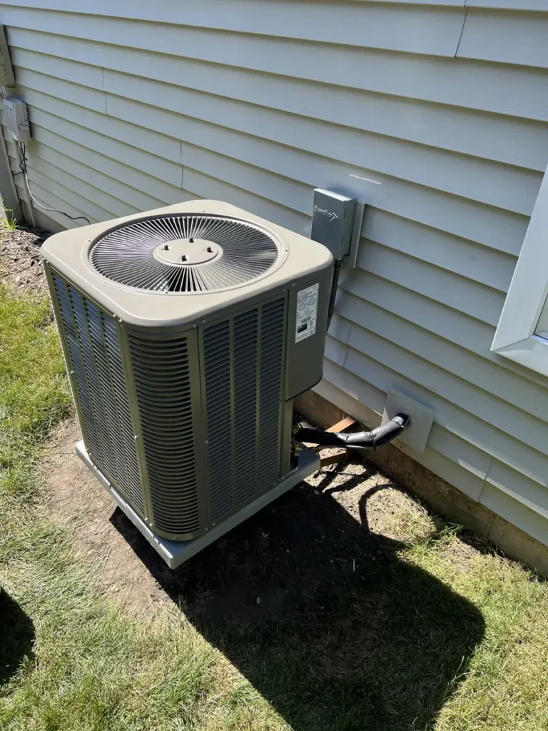 New Lennox air conditioner and disconnect beside an Elgin, IL home