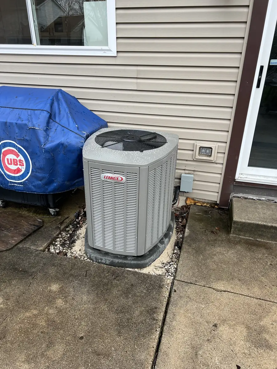 New Lennox Elite air conditioner on a pad at a Carol Stream, IL home