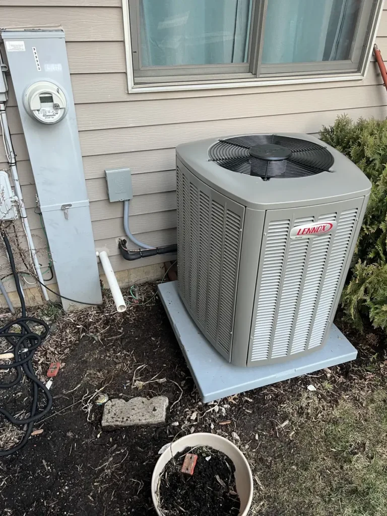 New Lennox Elite air conditioner on a new pad at an Elgin, IL home