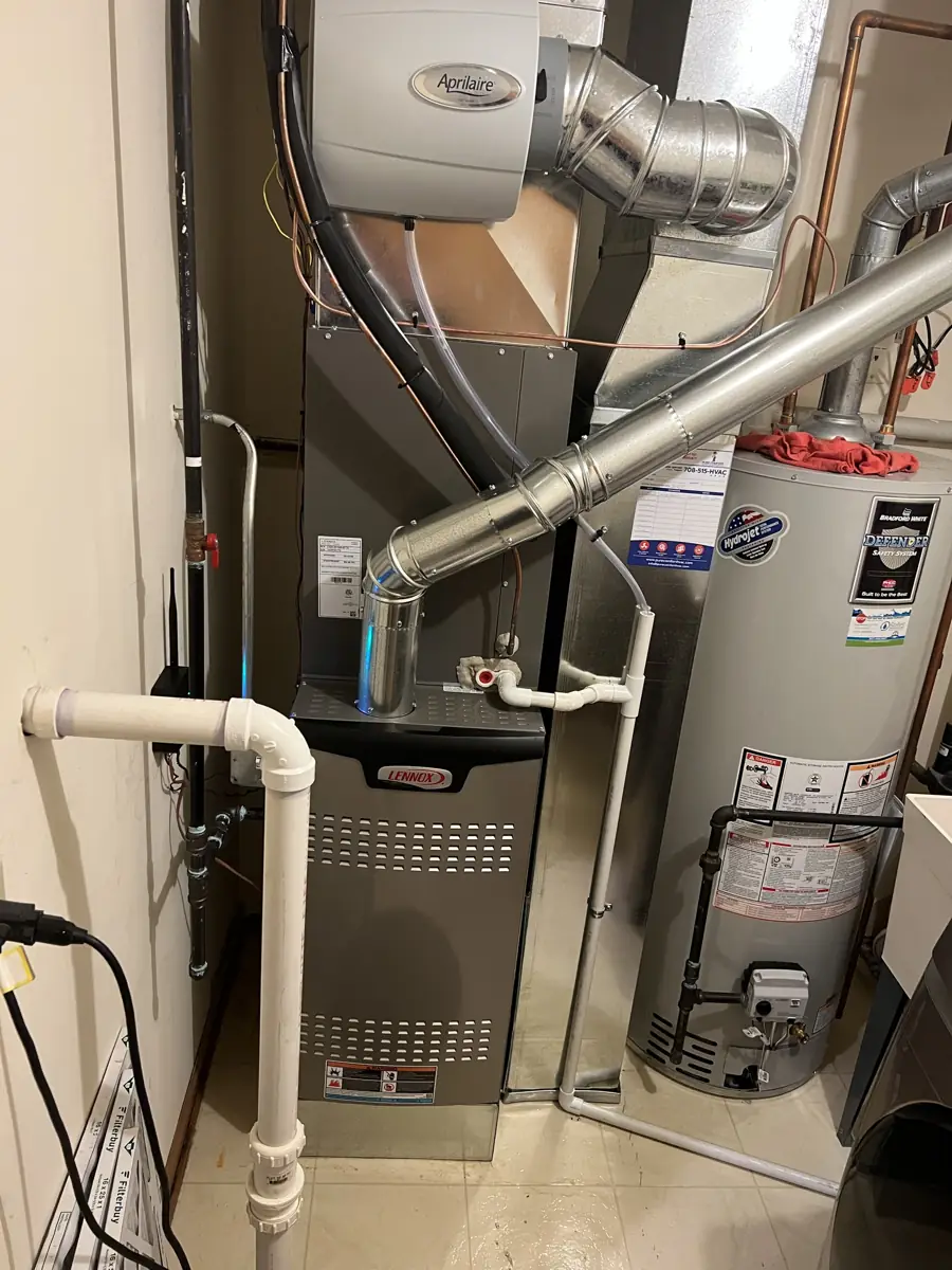 New Lennox furnace with an Aprilaire whole-house humidifier next to the water heater in Elgin, IL