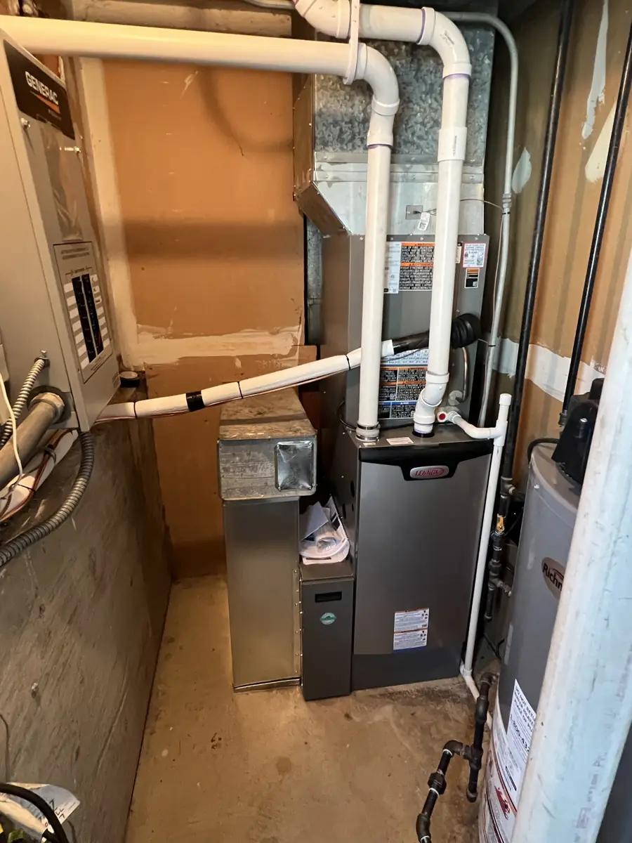 New Lennox high-efficiency furnace and coil with PVC venting in an Elmhurst, IL utility room