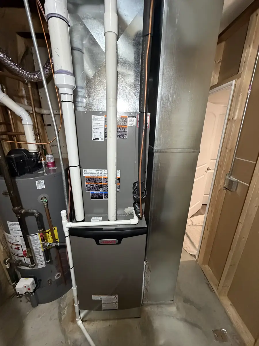 New Lennox high-efficiency furnace and coil with new sheet metal and PVC venting in a Glen Ellyn, IL basement