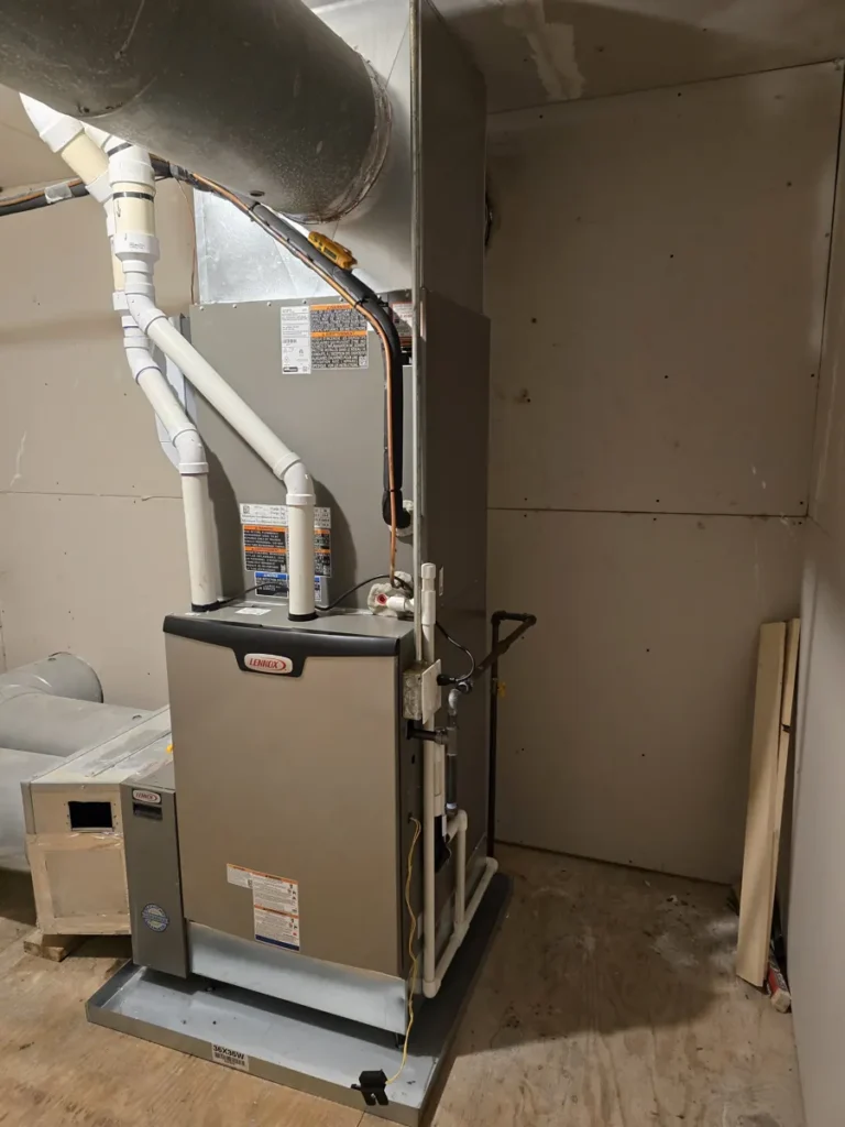 Side view of a new Lennox furnace with condensate drain and gas line in Bartlett, IL