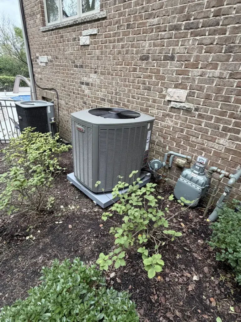 New Lennox central air conditioner beside a brick home in Bartlett, IL