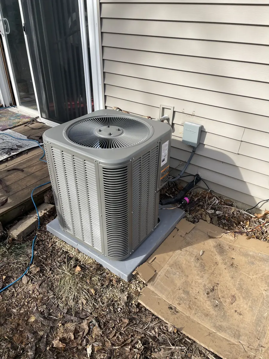 New Lennox air conditioner on a new pad beside a Schaumburg, IL home