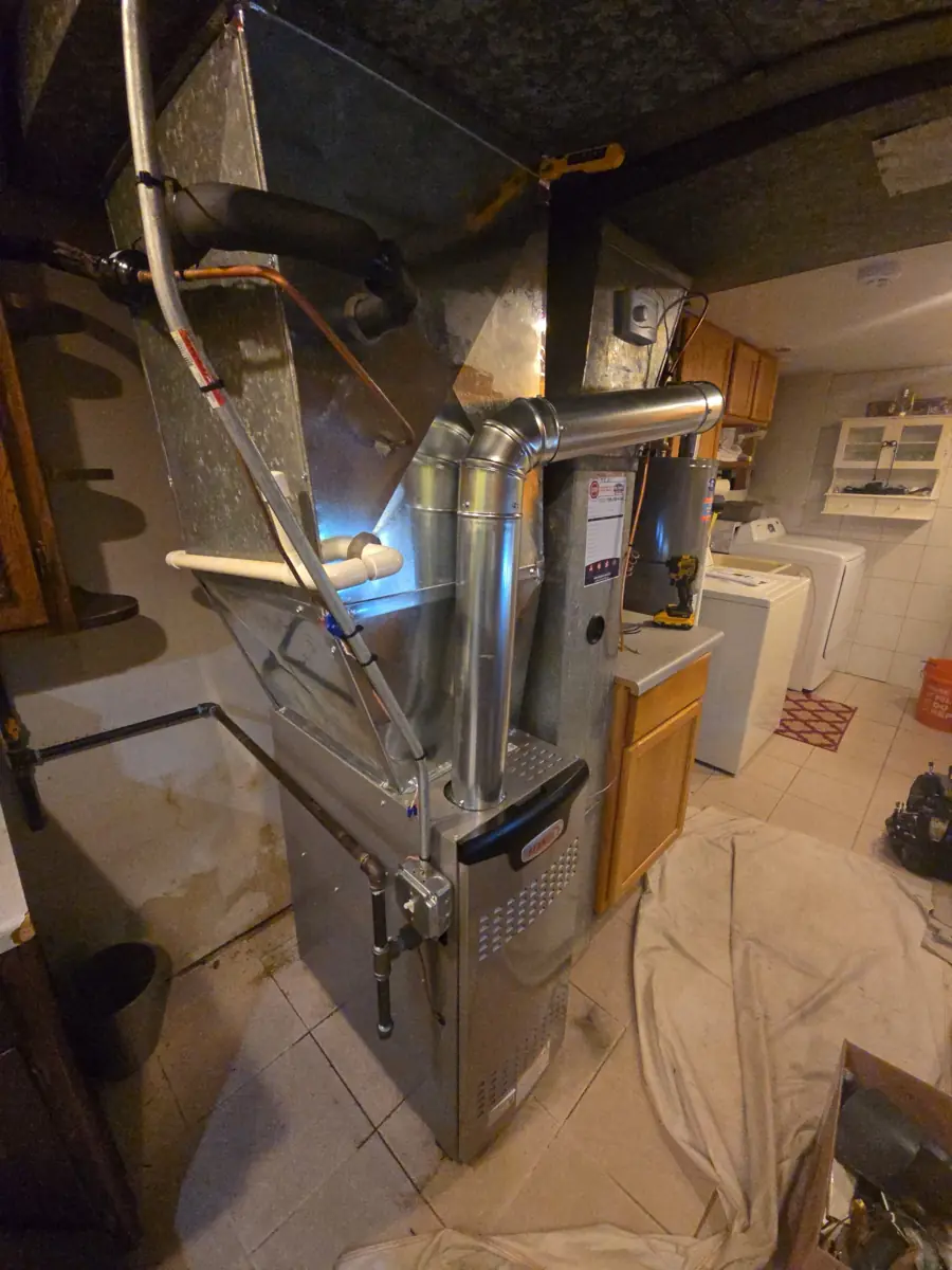 Side view of a new Lennox furnace with new sheet metal, venting and condensate piping in Streamwood, IL