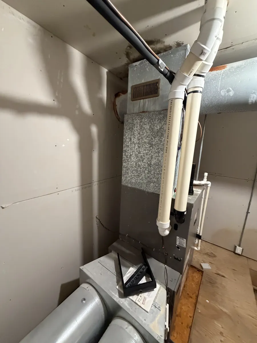 Old furnace in a Bartlett, IL basement closet before Pure Comfort replaced it