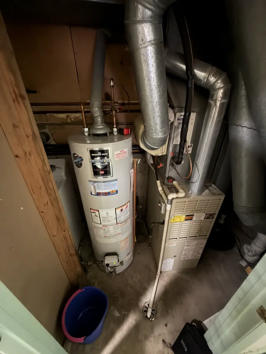 Original furnace and water heater in a Hanover Park, IL utility closet before replacement