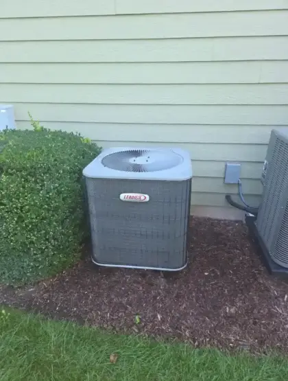 Older Lennox outdoor air conditioner before replacement in St. Charles, Illinois by Pure Comfort Heating & Cooling