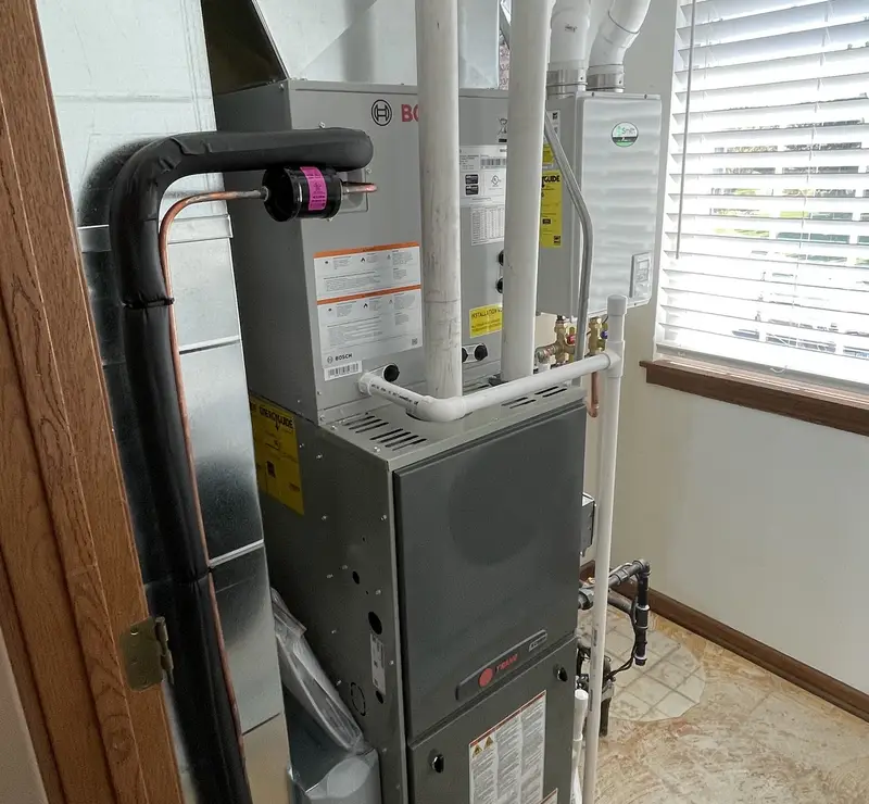 New Bosch AC coil and high-efficiency furnace installed by Pure Comfort in an Algonquin, IL utility room