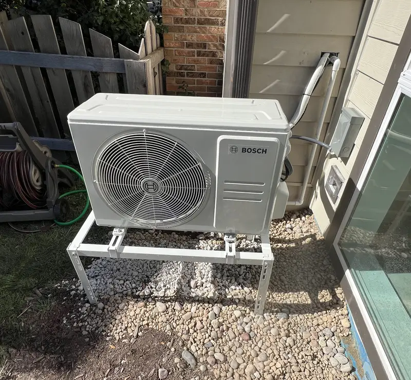 New Bosch ductless mini-split outdoor unit installed by Pure Comfort on a stand at a Wheaton, IL home