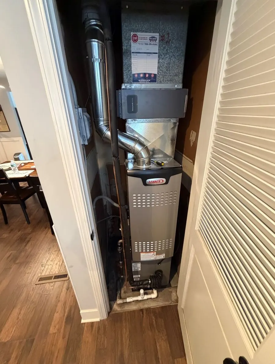 New Lennox furnace and humidifier in a hallway closet installed in Streamwood, Illinois by Pure Comfort Heating & Cooling