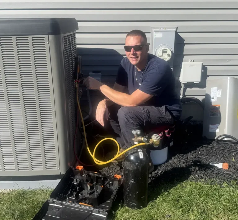 Pure Comfort technician checking refrigerant pressures on an outdoor unit