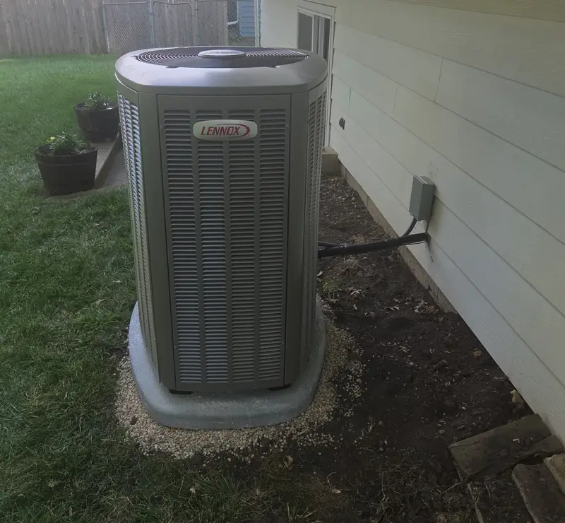 New Lennox air conditioner on a pad in the backyard of an Elk Grove Village, IL home