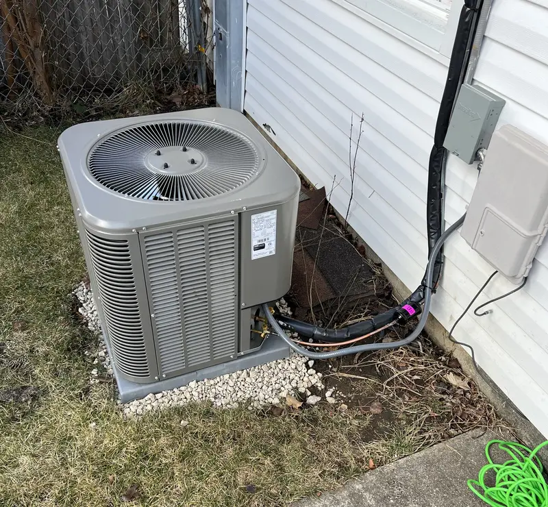 New Lennox air conditioner on a pad with new line set at a Glendale Heights, IL home