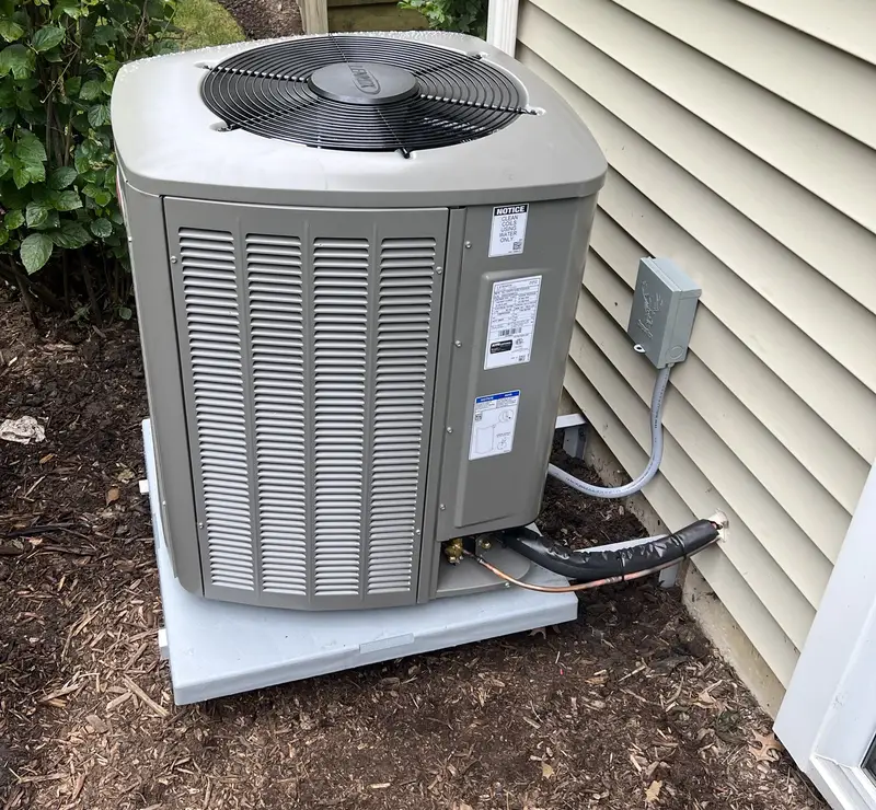 New Lennox air conditioner on a pad beside a St. Charles, IL home