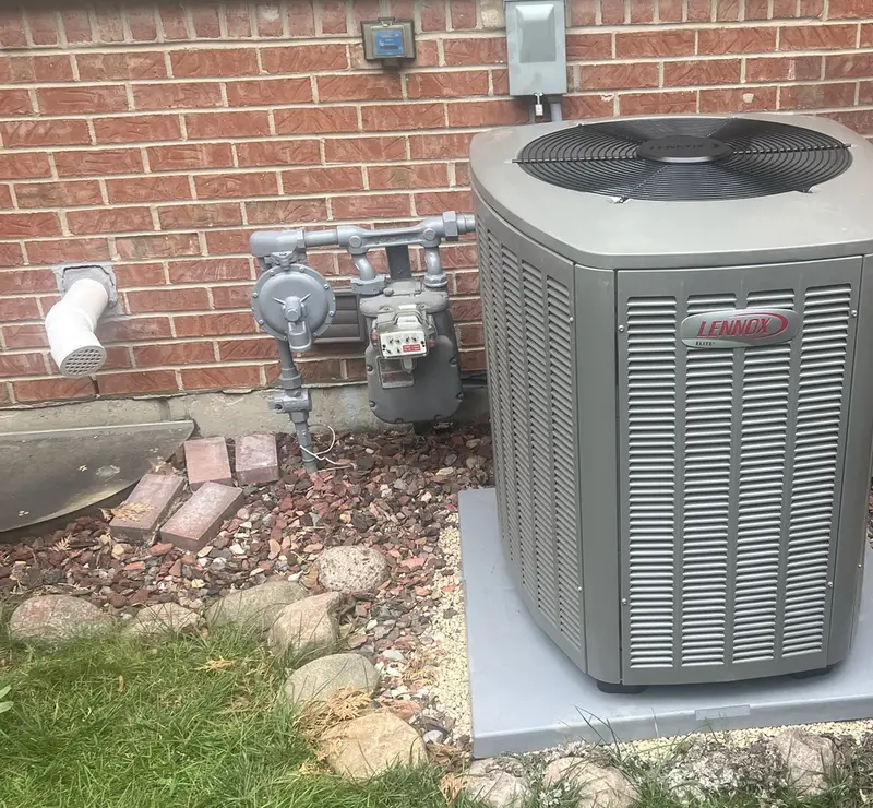 New Lennox Elite air conditioner on a new pad at a Bloomingdale, IL home