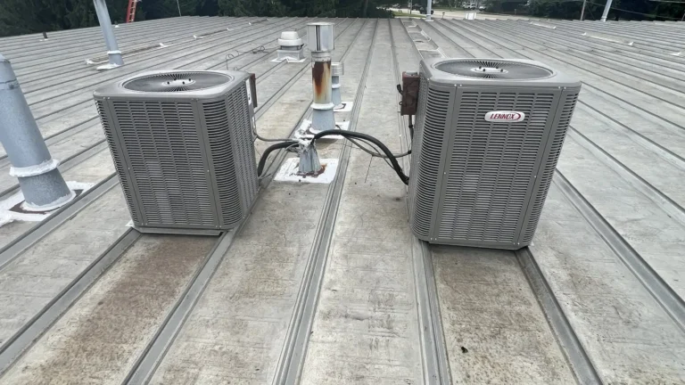 Two new Lennox air conditioners installed by Pure Comfort on a rooftop in Bloomingdale, IL