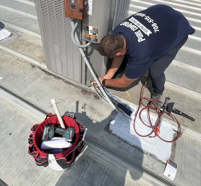 Pure Comfort technician connecting a new Lennox rooftop air conditioner in Bloomingdale, IL
