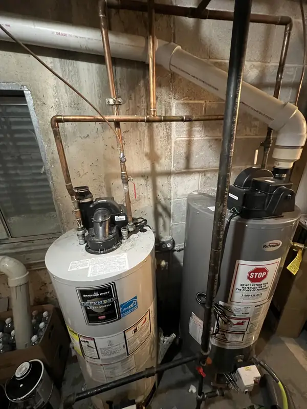Before: two aging power-vent water heaters in a Des Plaines, IL basement